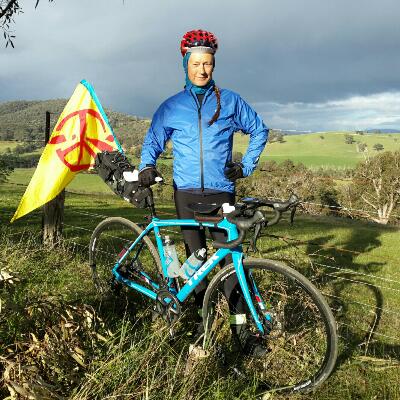 Me bike packing with ICAN flag