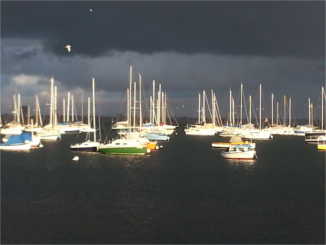 boats with grey sky and water